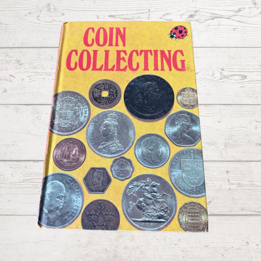 Book titled 'Coin Collecting' with images of coins on a yellow background