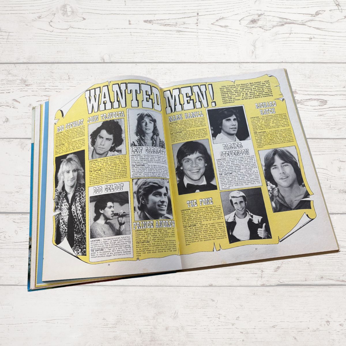 Open book with a 'WANTED: MEN!' poster featuring black and white photos on a light wooden surface.