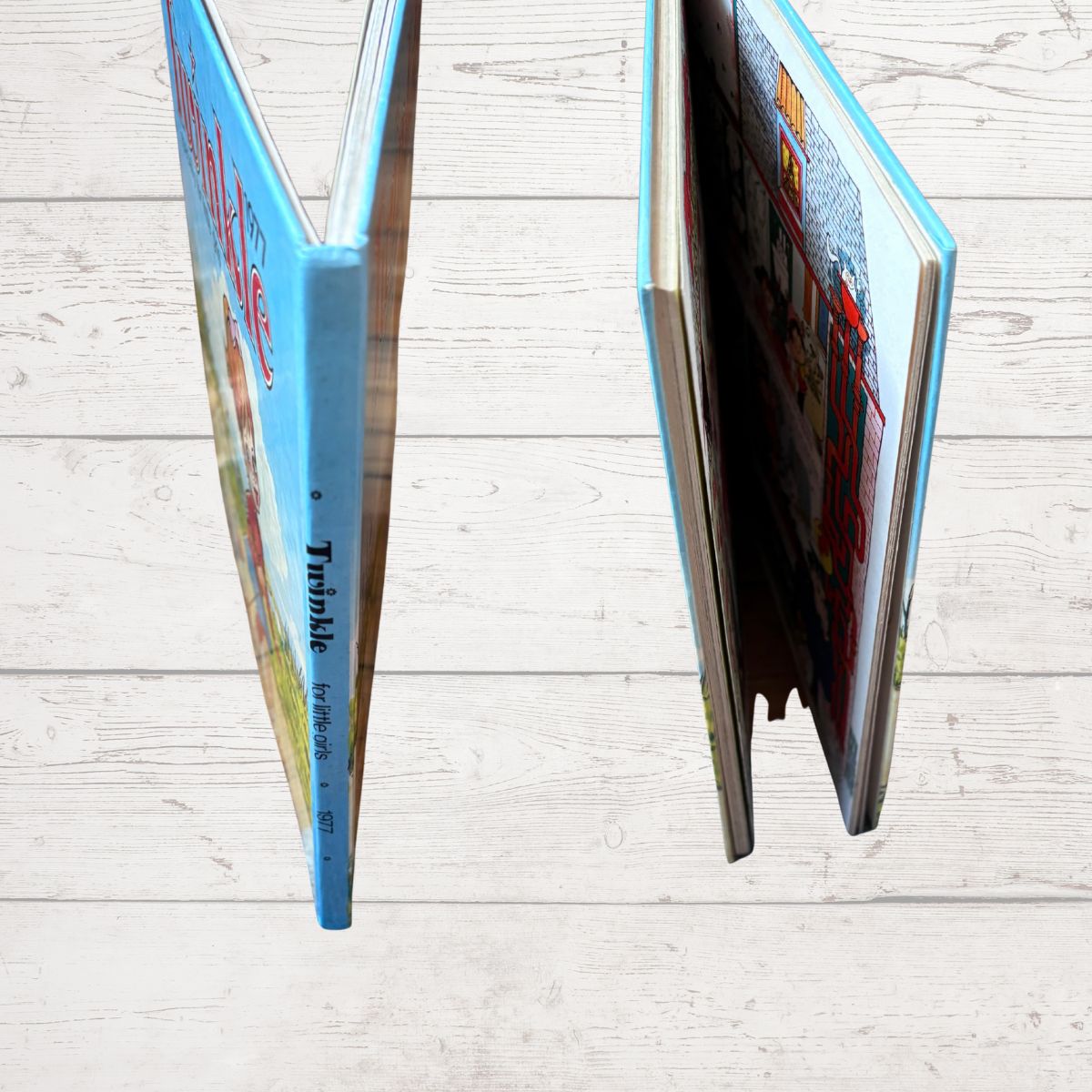 A hardcover book titled 'Twinkle' shown standing open and closed