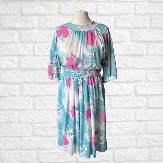 Floral dress on a mannequin against a white brick wall background