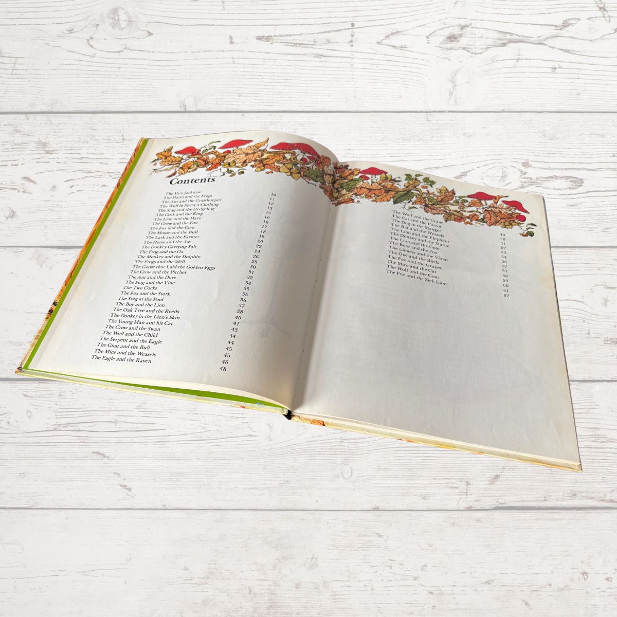 Open book with decorative cover on a wooden surface