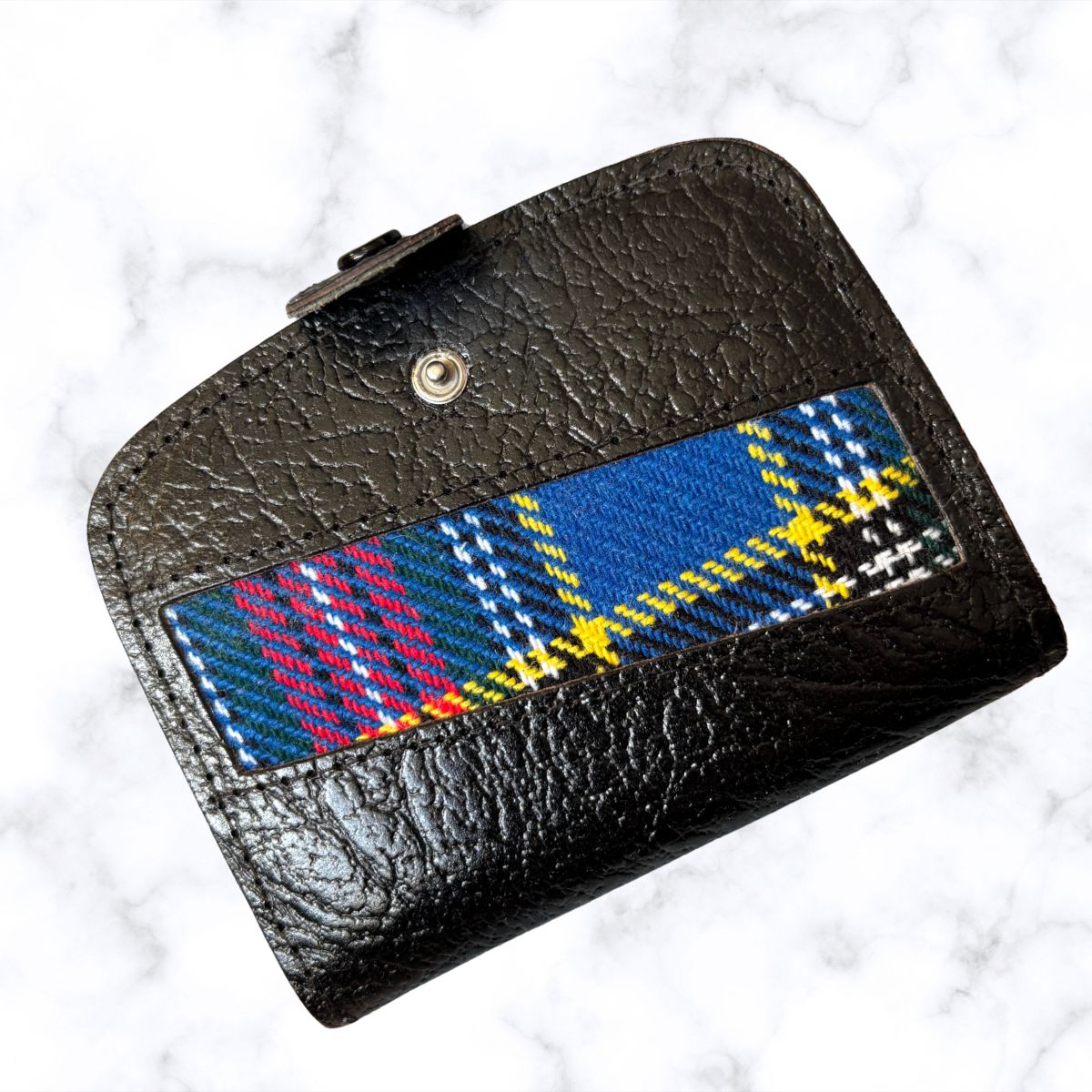 Black leather wallet with a plaid pattern on a white background