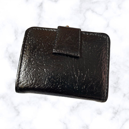 Black  leather wallet on a white marble surface