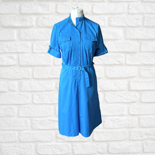 Blue dress on a mannequin against a white brick wall background