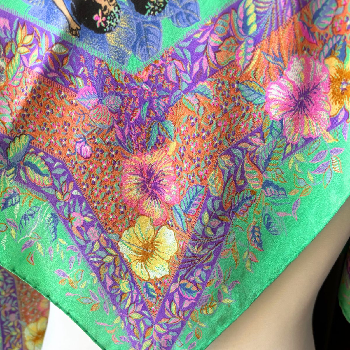 Colorful floral patterned fabric with vibrant colors on a white background