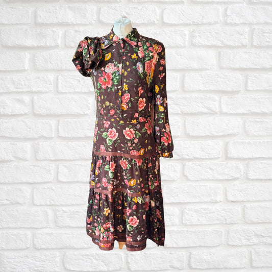 Floral dress on a mannequin against a white brick wall background
