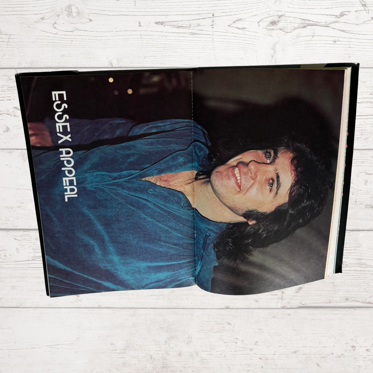 Book or magazine with a person on the cover and 'Essex Appeal' text, on a wooden surface.