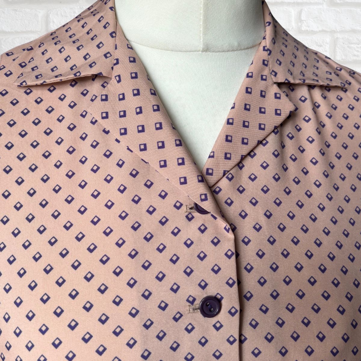 Patterned dress with purple  geometric design on a white background