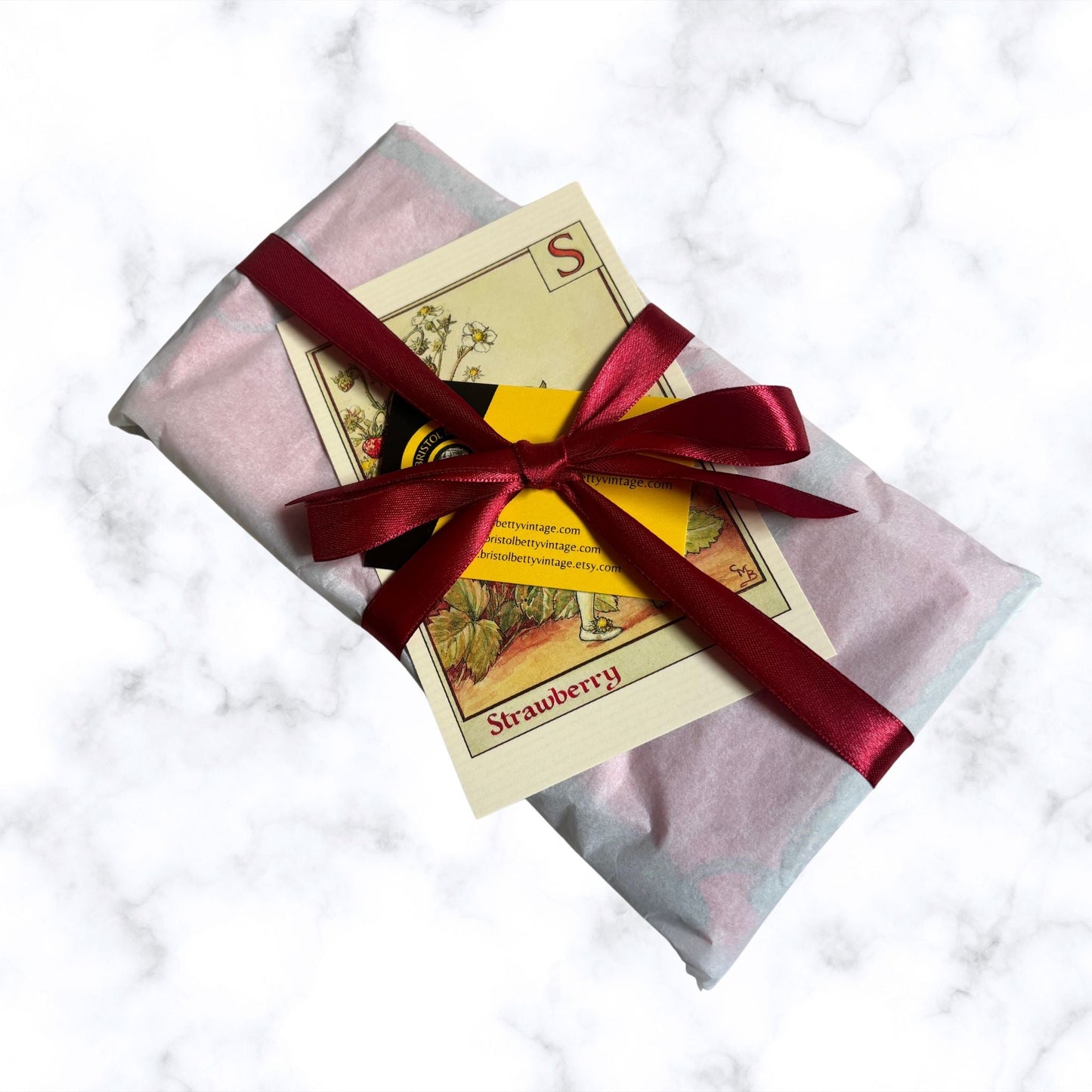 Gift package with a red ribbon on a marble surface