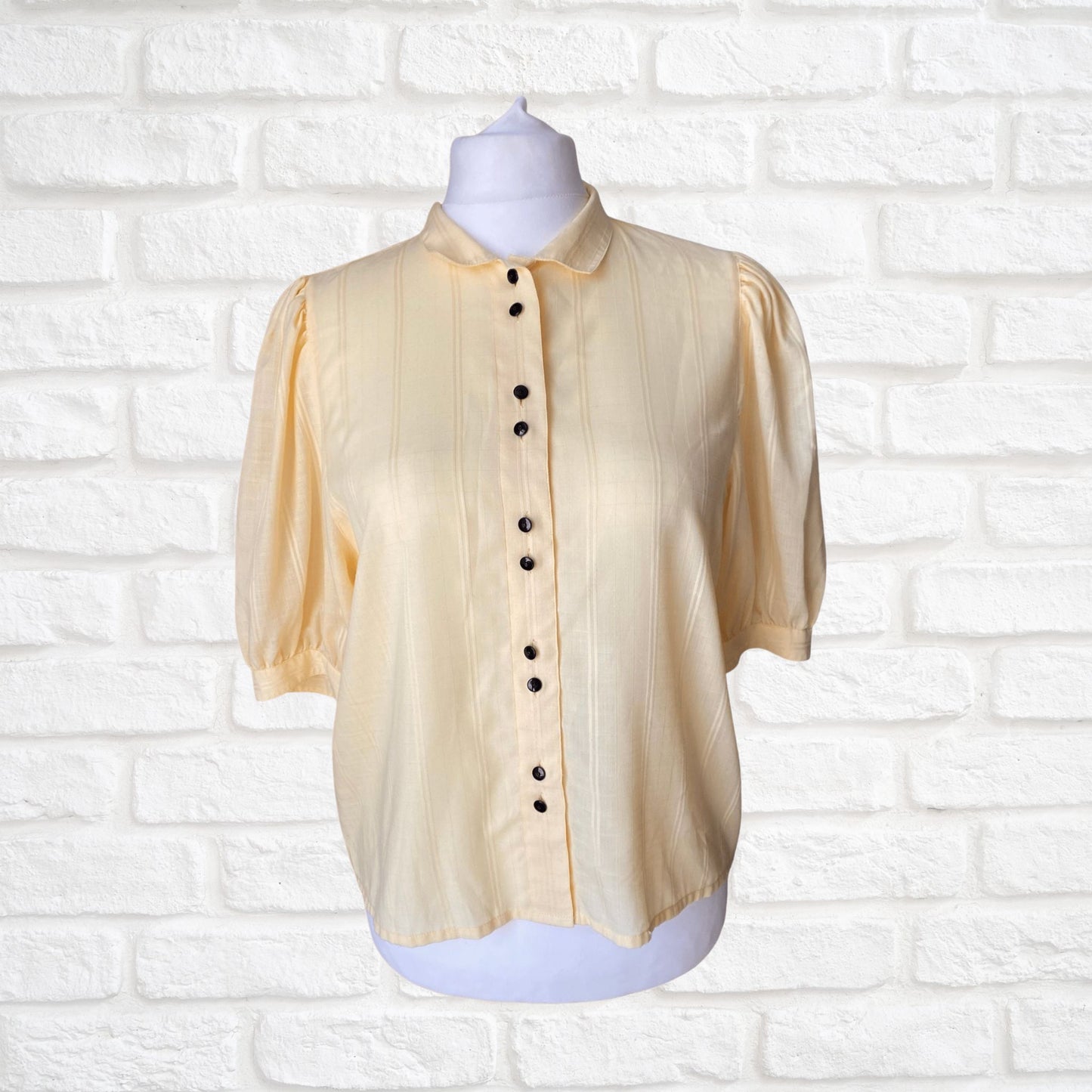Yellow 80s blouse with black buttons and puffed short sleeves. Approx  U .K. size  14-18