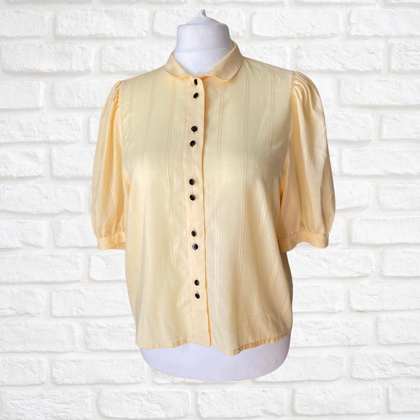 Yellow 80s blouse with black buttons and puffed short sleeves. Approx  U .K. size  14-18