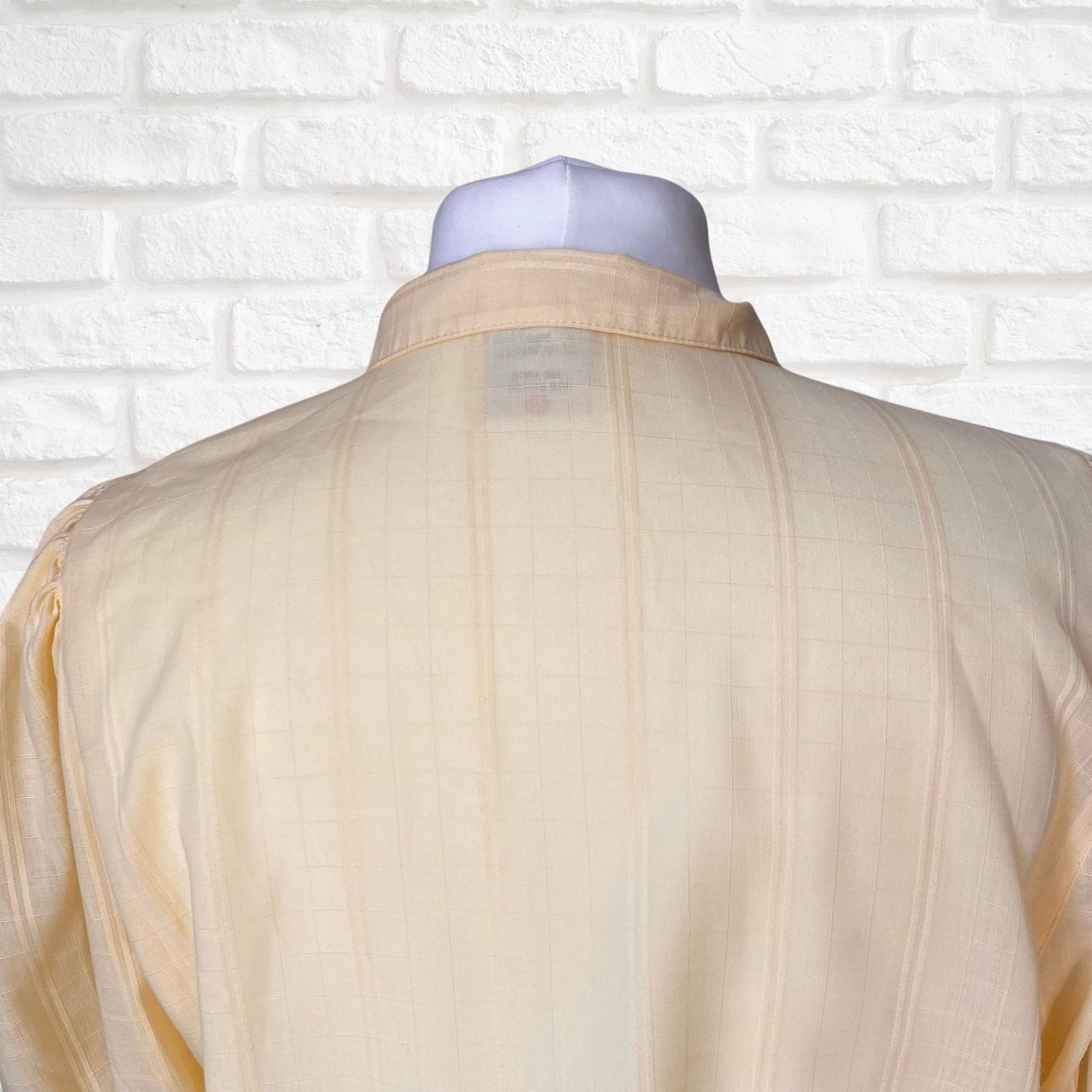 Yellow 80s blouse with black buttons and puffed short sleeves. Approx  U .K. size  14-18