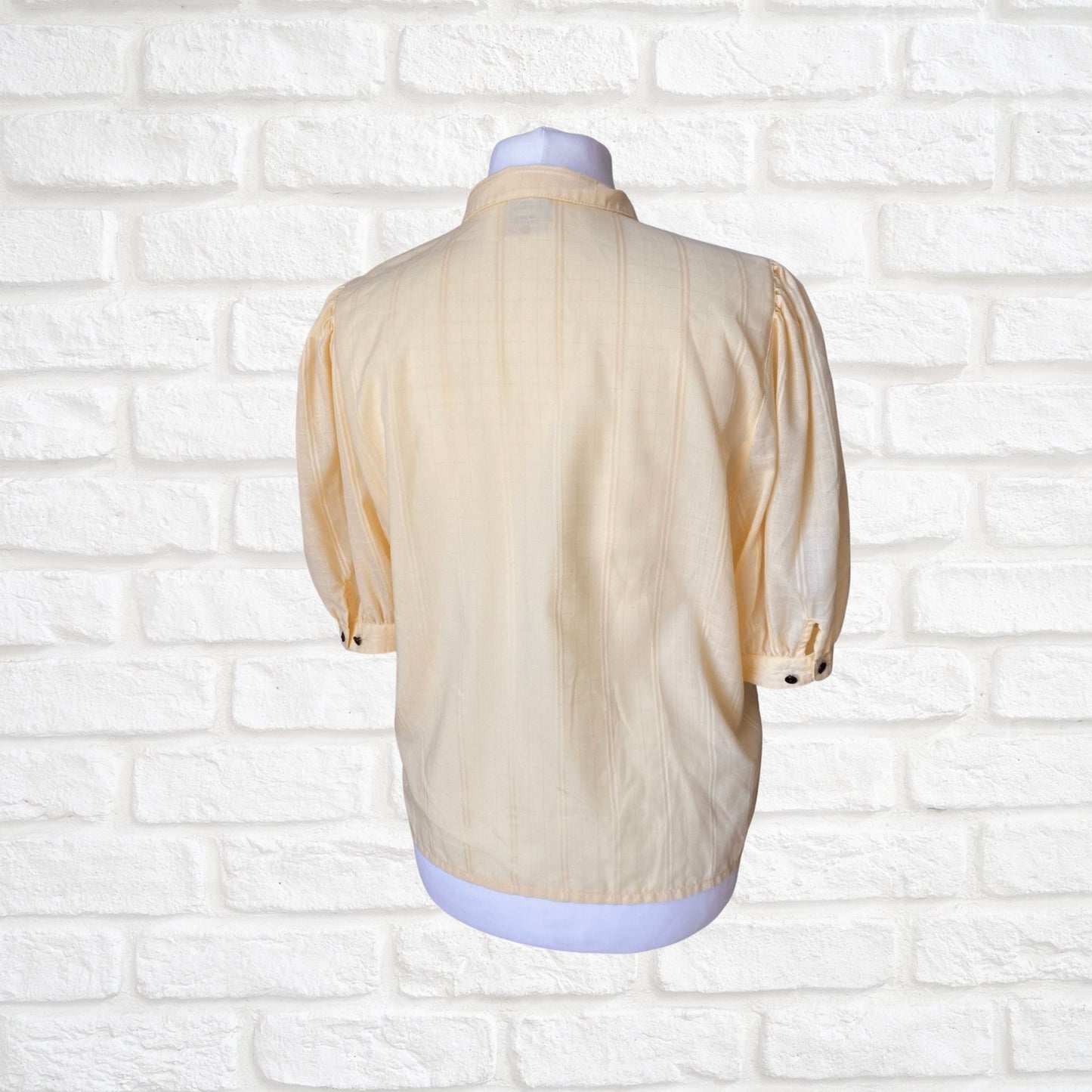 Yellow 80s blouse with black buttons and puffed short sleeves. Approx  U .K. size  14-18
