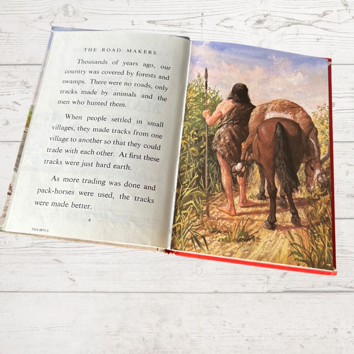 Open book with text and illustration of a Native American on a horse