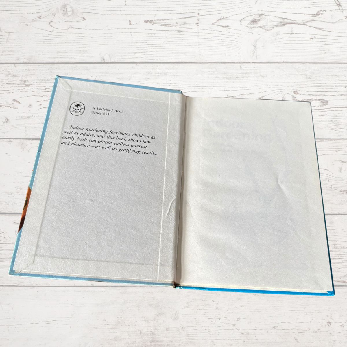 Open book on a wooden surface with text visible