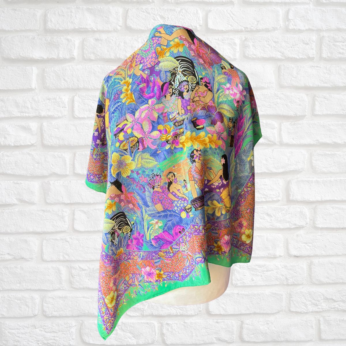 Colorful scarf with a vibrant design on a white brick wall background