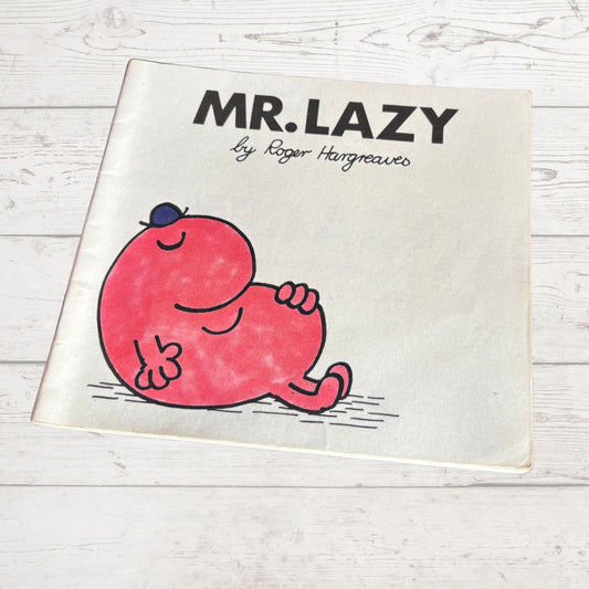 Book titled 'Mr. Lazy' by Roger Hargreaves on a wooden surface