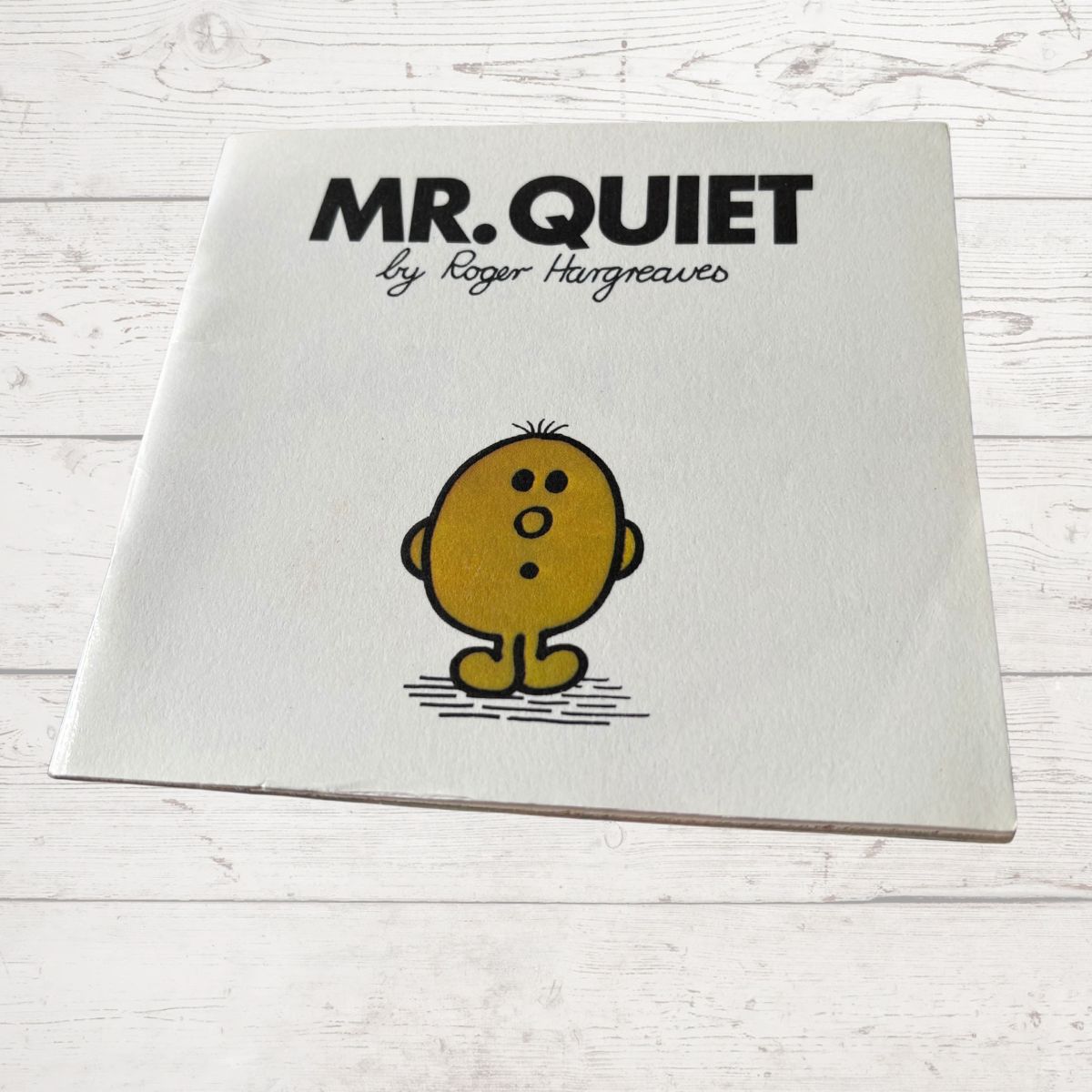 Book titled 'Mr. Quiet' by Roger Hargreaves on a white wooden surface