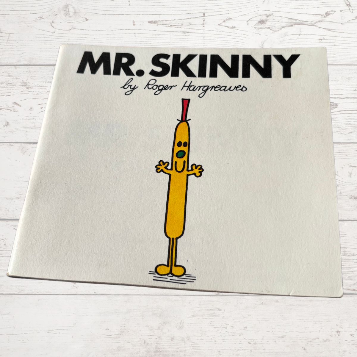 Book titled 'Mr. Skinny' by Roger Hargreaves on a light wooden surface