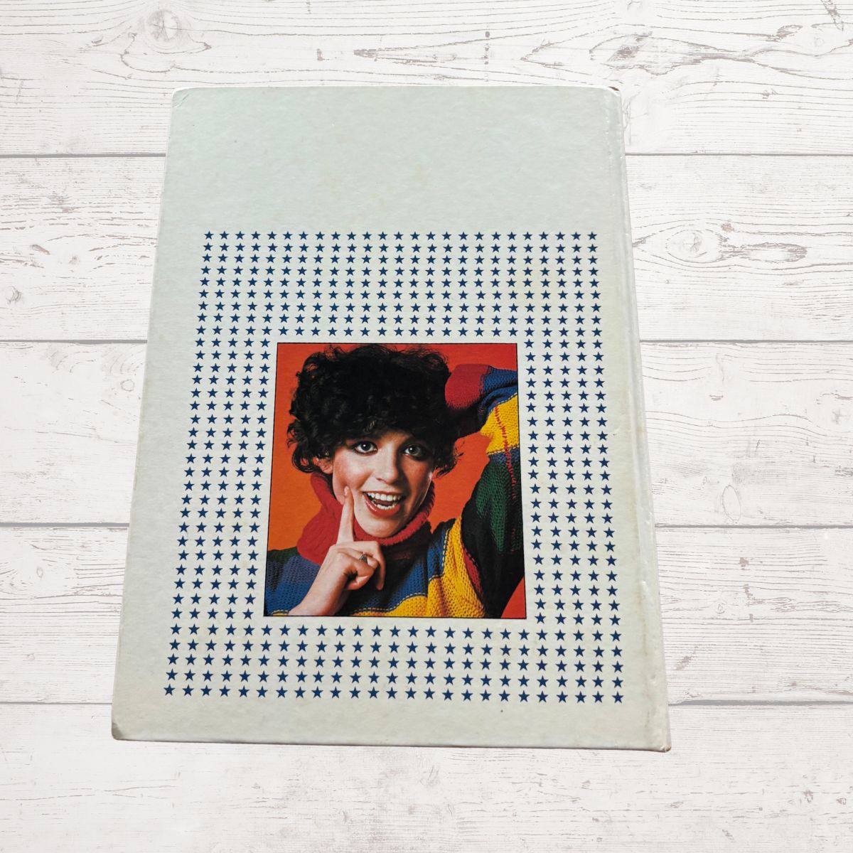 Annual  with a portrait of a person in a colourful outfit on a star-patterned background