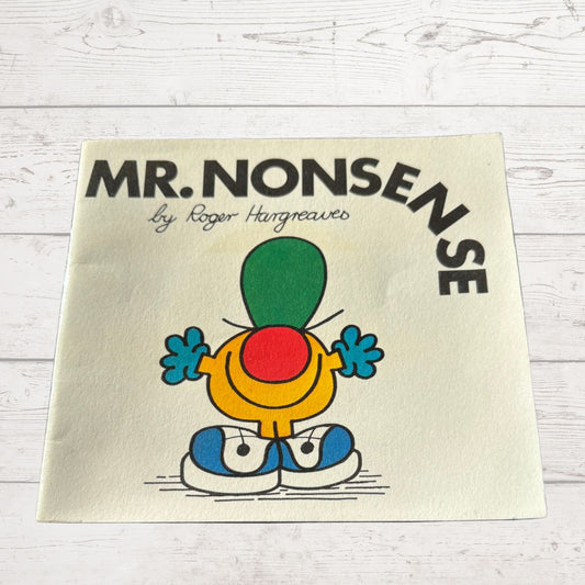 Book cover of 'Mr. Nonsense' by Roger Hargreaves on a light wooden surface