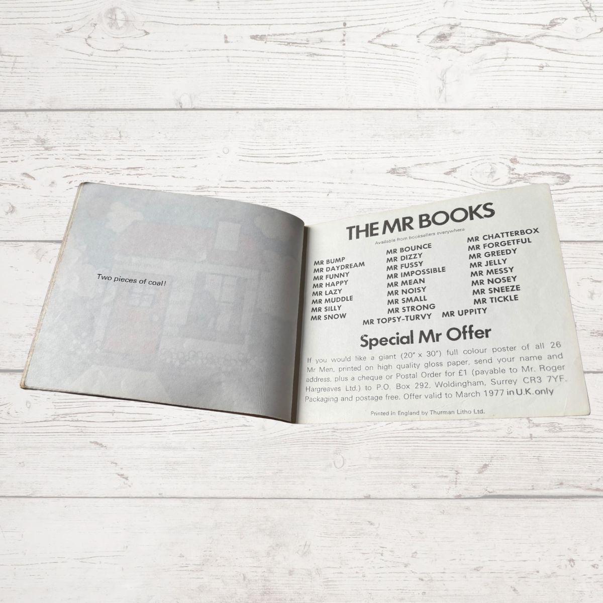 Open book with text on a wooden surface