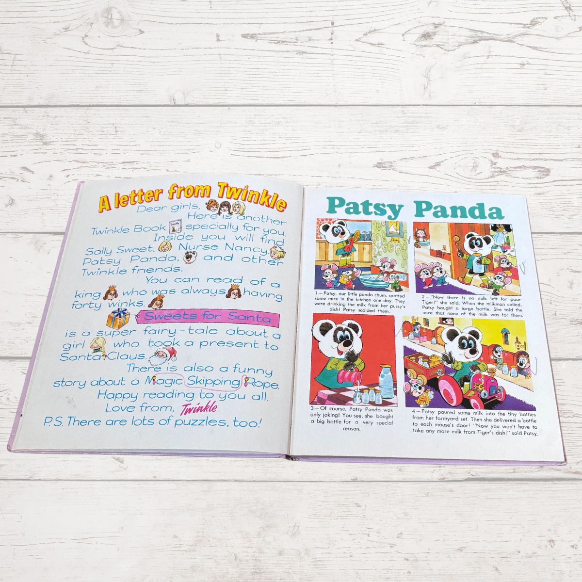An open children's book spread laid on a white wood surface, showing two printed pages with colorful text and cartoon illustrations including the title 'A letter from Twinkle' and 'Patsy Panda'.