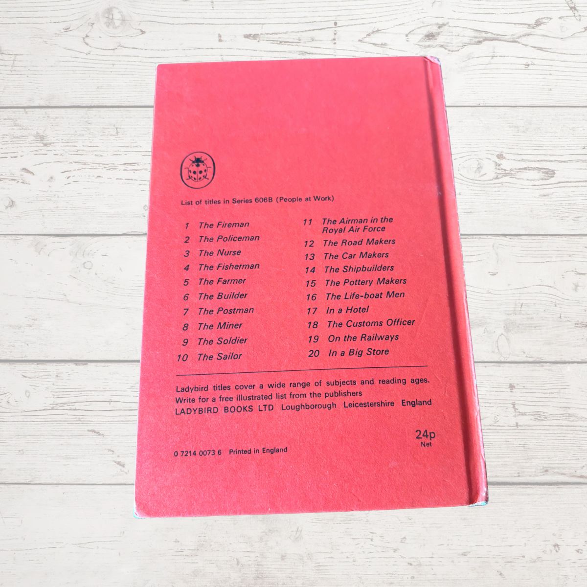 Red book with text on a wooden surface