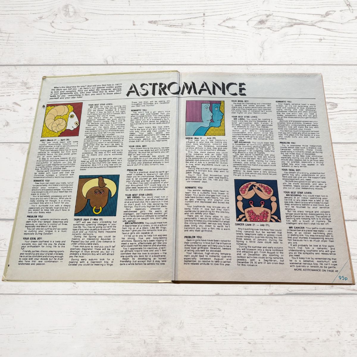 Open book with 'Astromance' section on a wooden surface