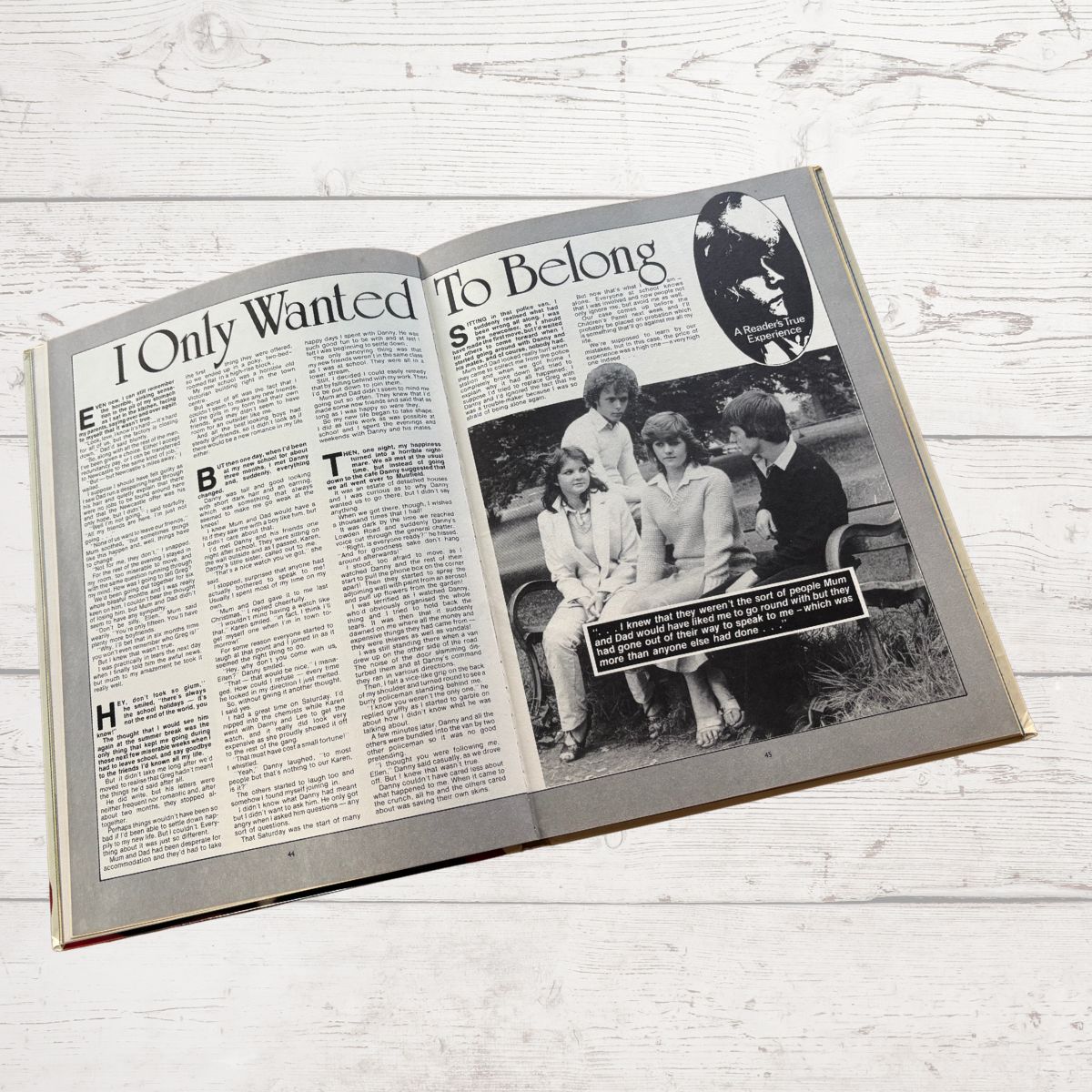 Open book with black and white photo and text on a wooden surface