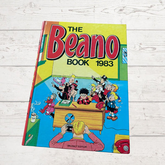 Vintage 'The Beano Book 1983' comic on a wooden surface