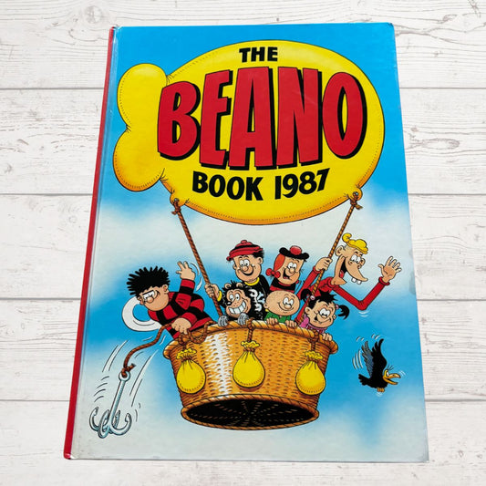 Cover of 'The Beano Book 1987' with cartoon characters on a blue background