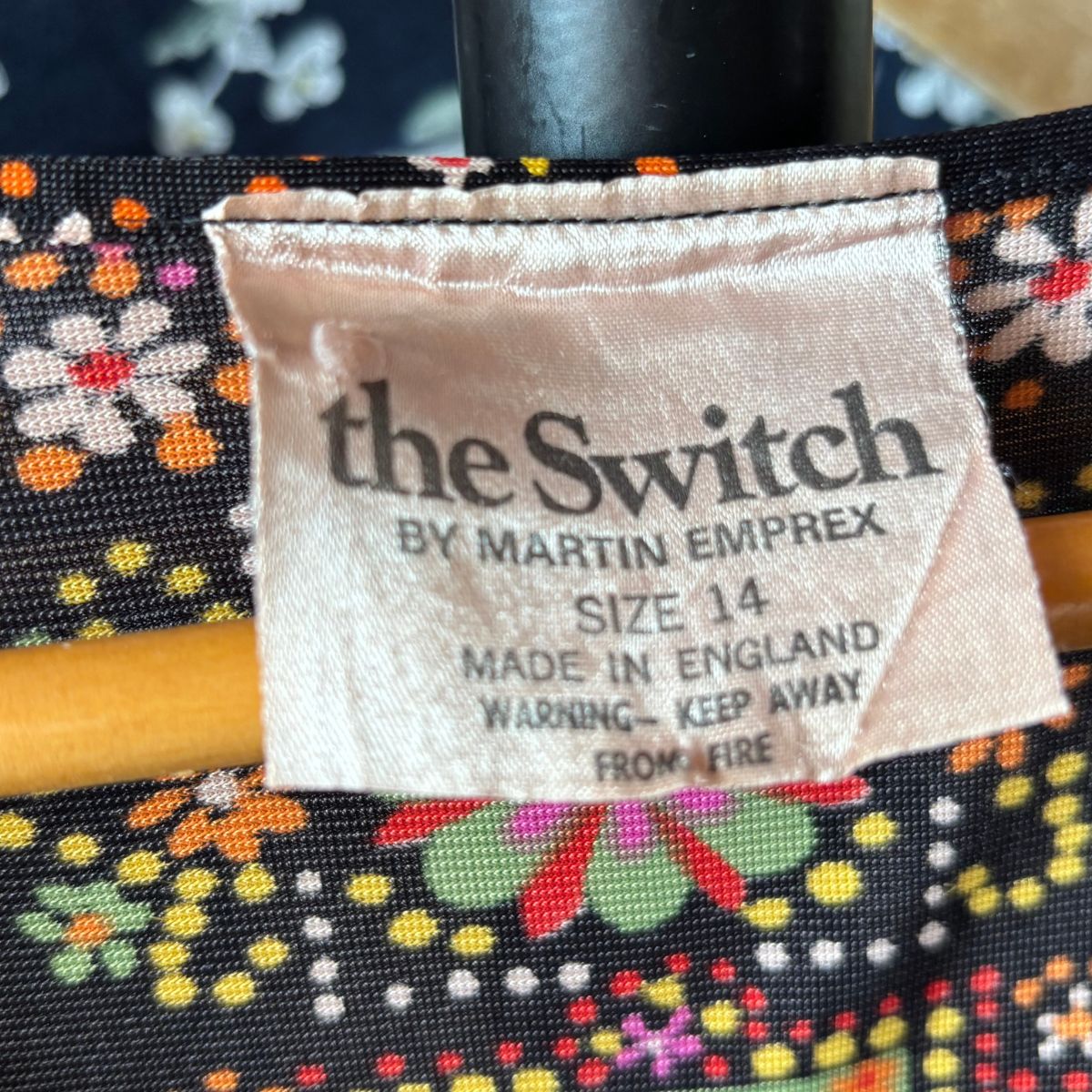 Label on a product with 'the Switch by Martin Emprex' text and colorful floral pattern.