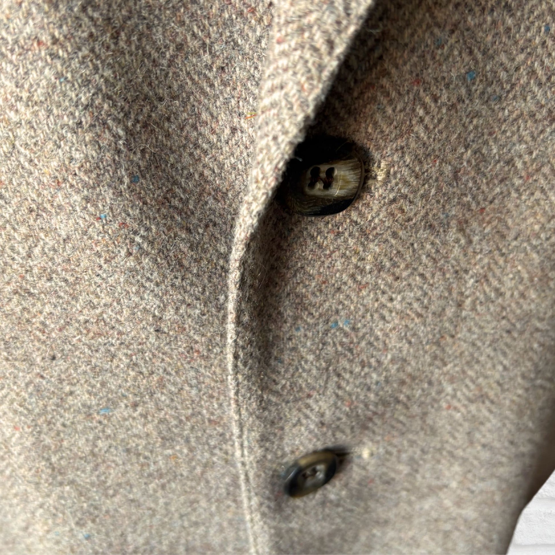 Close-up of a textured fabric surface with a button