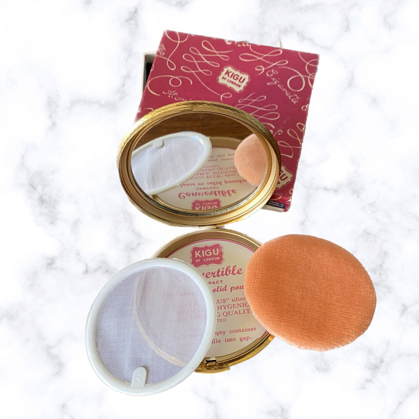 60s gold tone boxed and unused KIGU powder compact