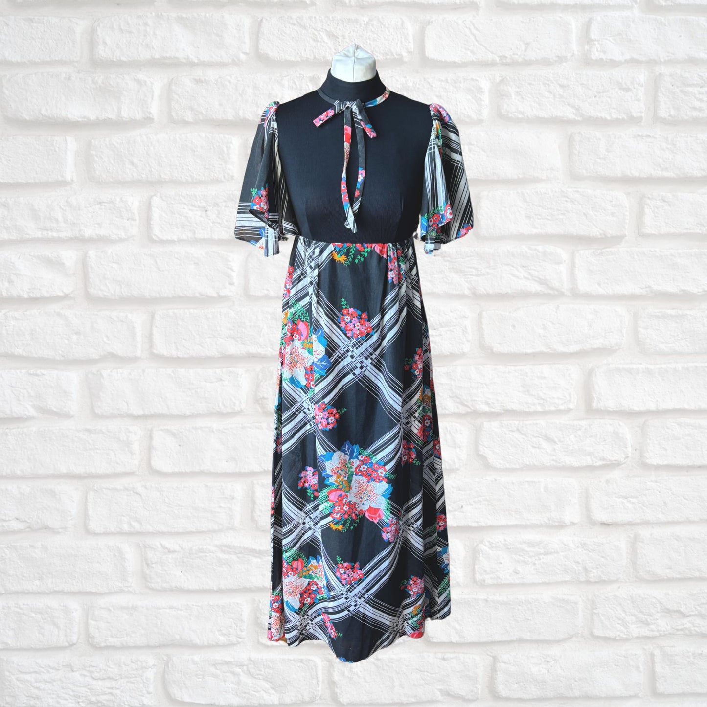 70s vintage maxi dress by Richard Shops with black high neck bodice and floral skirt - full length front view
