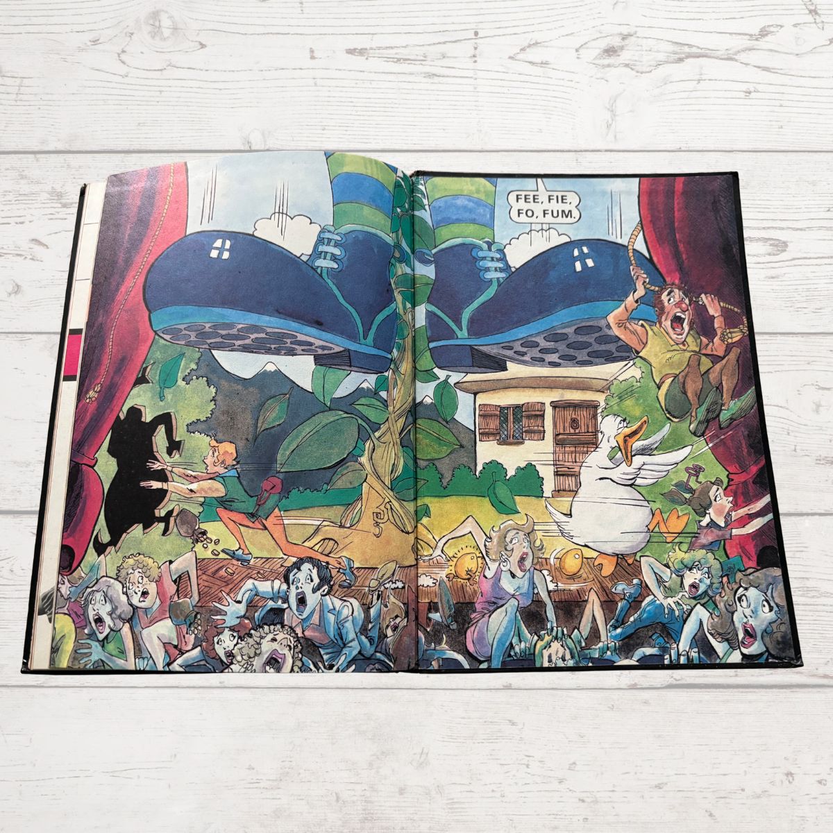 Open comic book with colorful illustrations on a wooden surface