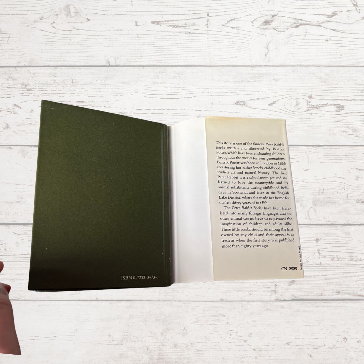 Open book on a wooden surface with text visible