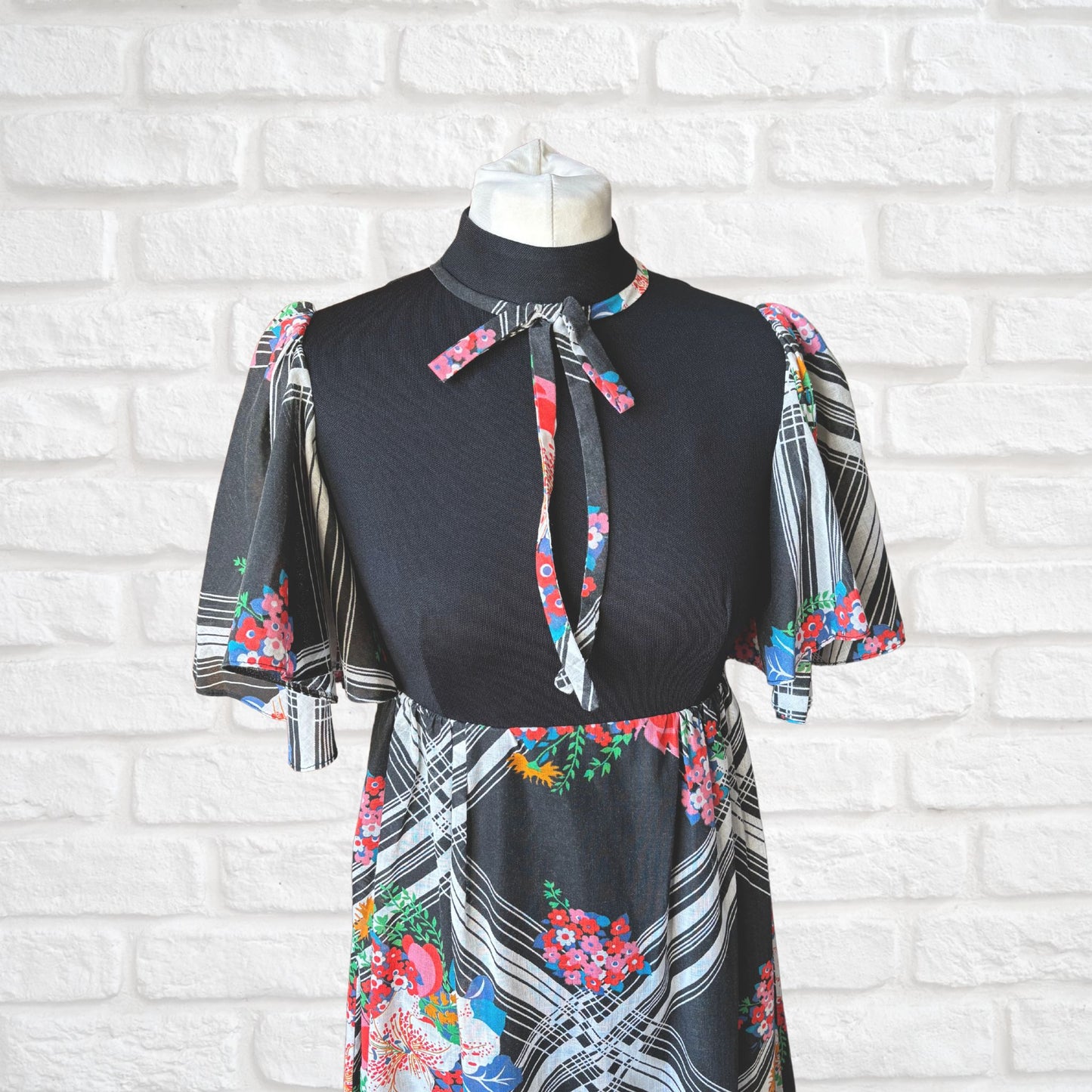 70s vintage maxi dress by Richard Shops with black high neck bodice and floral angel sleeves - top front view