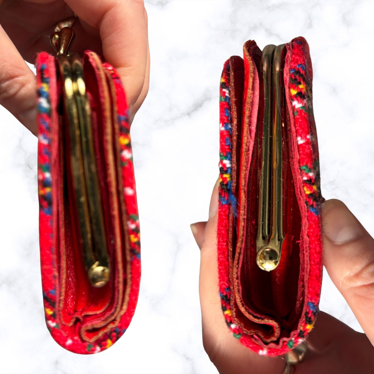 Red wallet with colorful patterns held by a hand on a white background