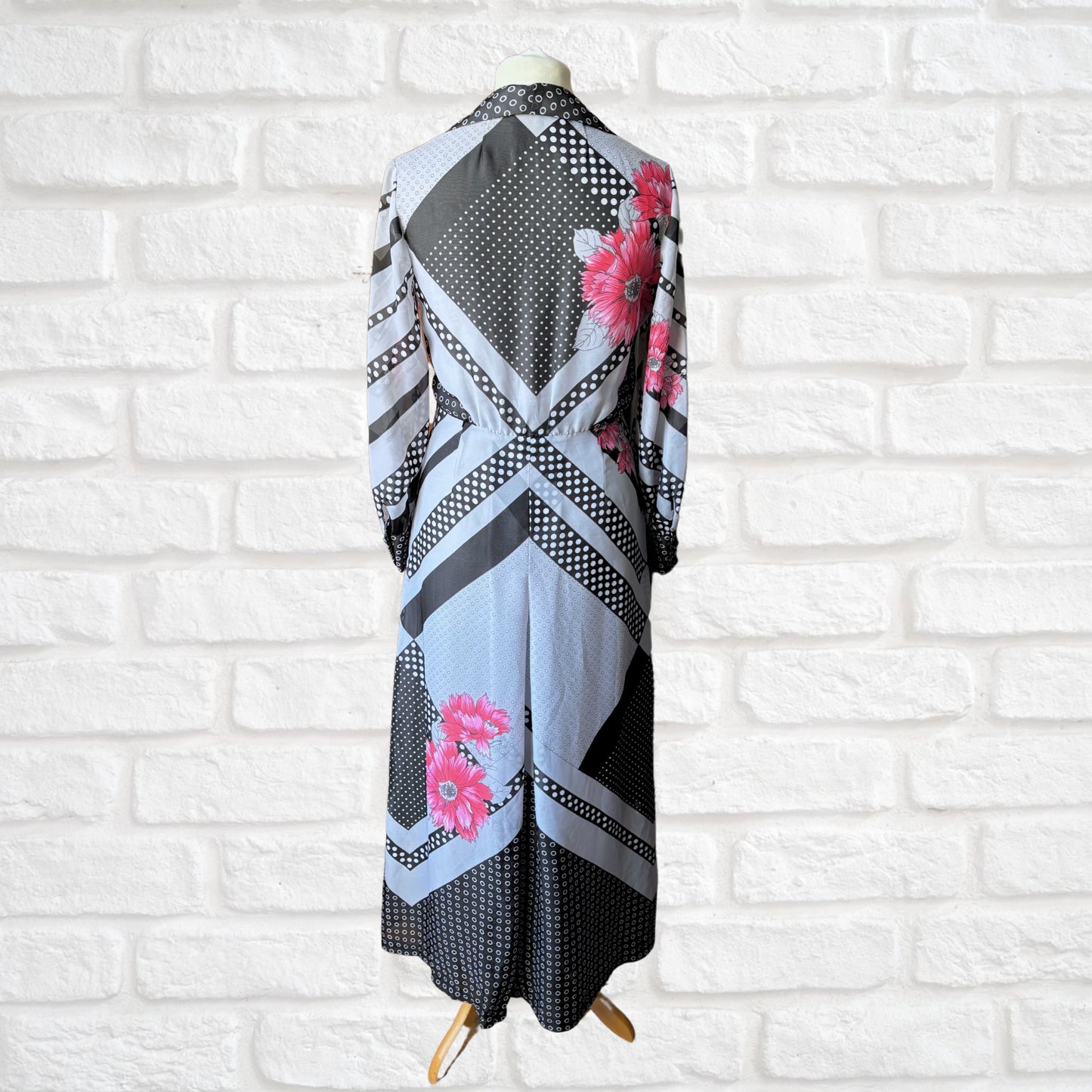 70s vintage long-sleeved maxi dress with grey and black stripes, polka dots, and floral design - back full length view