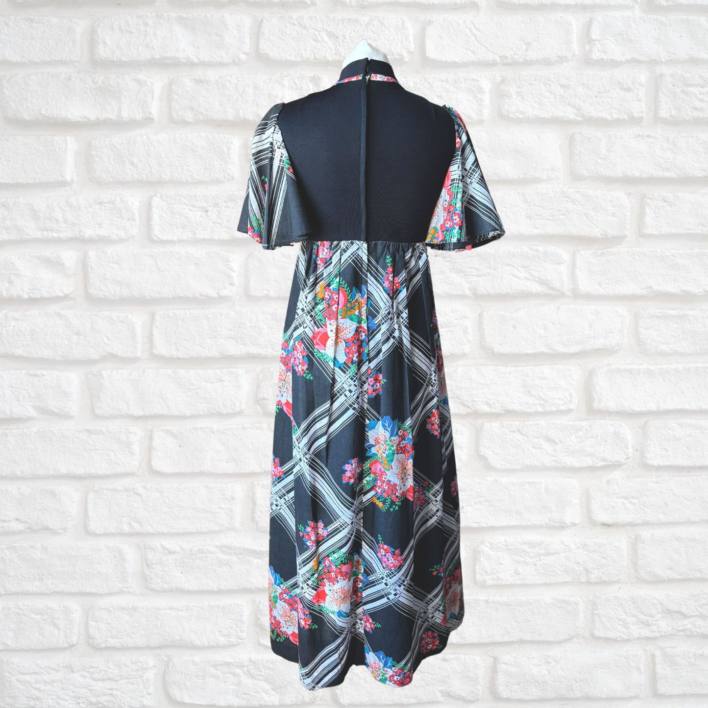 70s vintage maxi dress by Richard Shops with black high neck bodice and floral skirt - full length back view