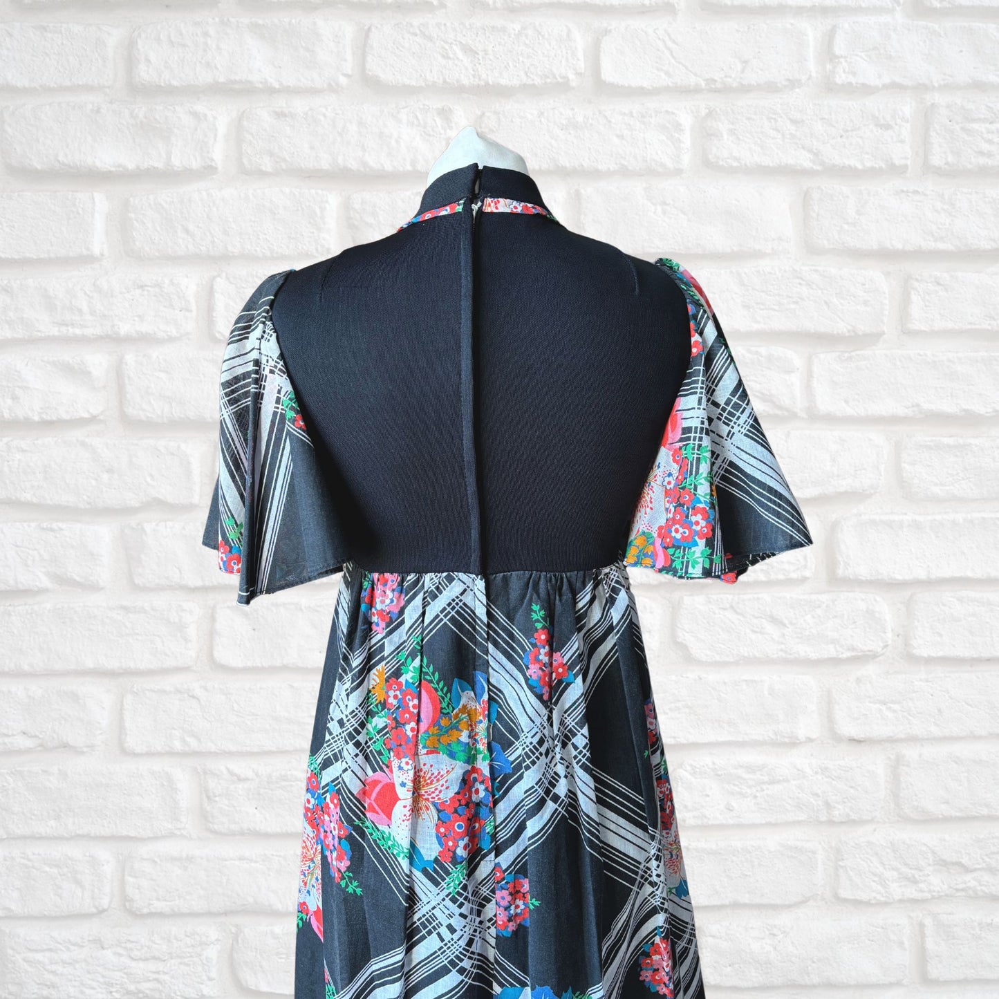 70s vintage maxi dress by Richard Shops with black high neck bodice and floral skirt - top back view