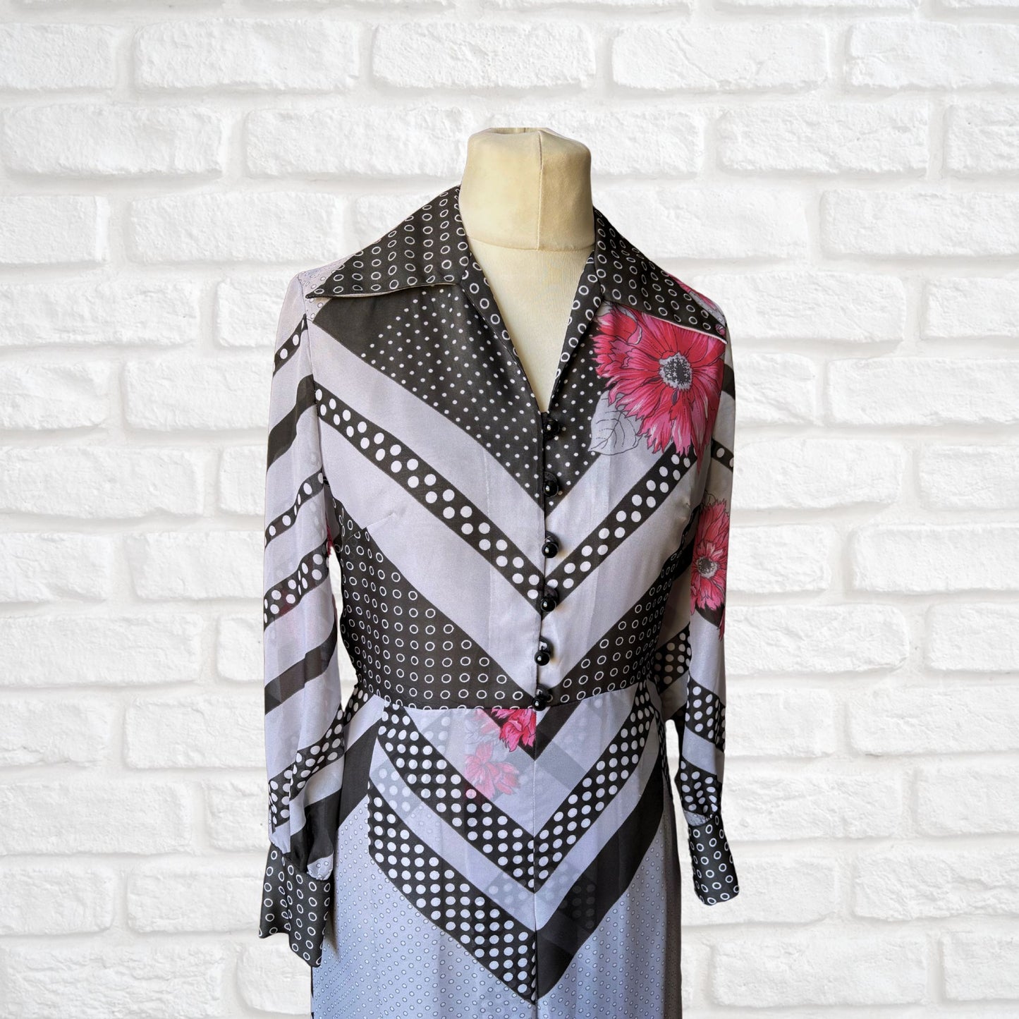 70s vintage long-sleeved maxi dress with grey and black stripes, polka dots, and floral design - top front view
