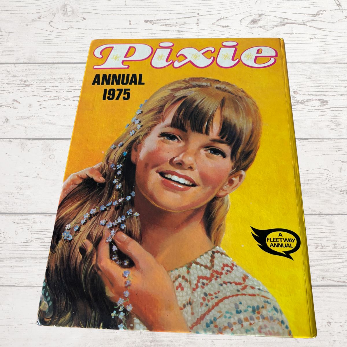 Vintage 'Pixie Annual 1975' book cover with a girl on a yellow background