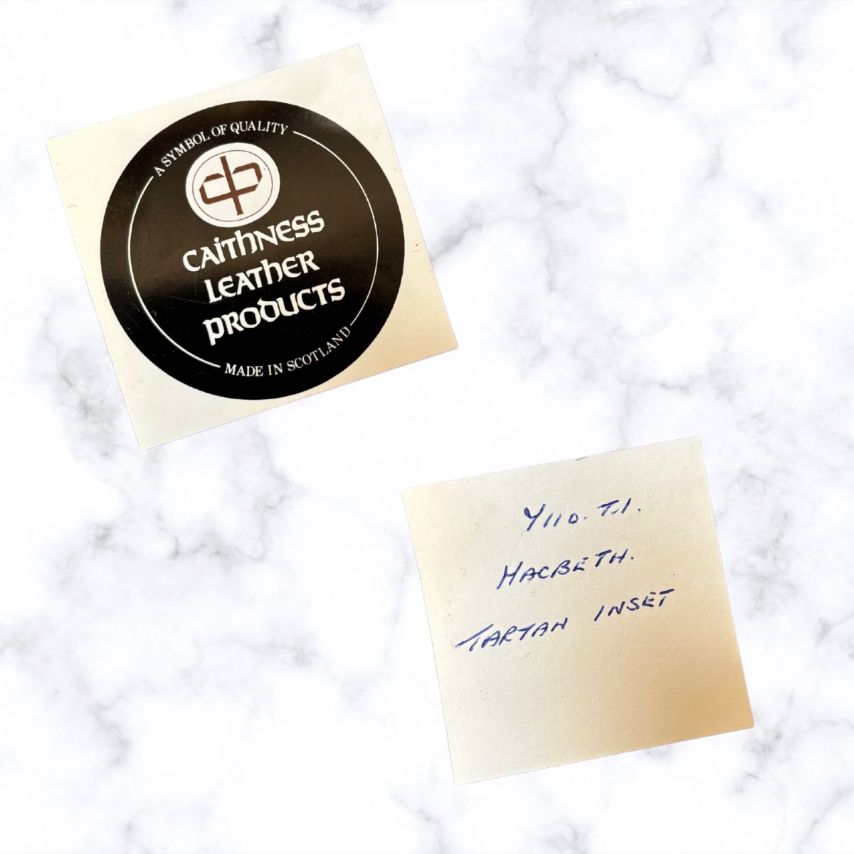 Caithness  Leather Products label on a marble surface with a handwritten note.