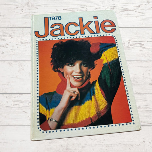 Magazine cover titled 'Jackie' from 1978 featuring a person in a colorful sweater on a wooden surface.