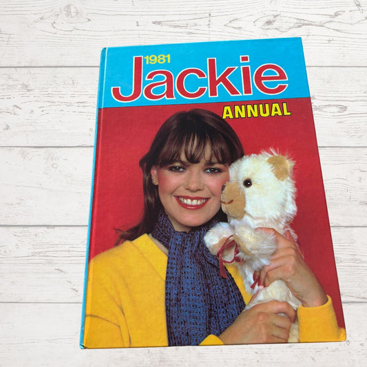 1981 Jackie Annual cover with a girl holding a teddy bear on a wooden surface