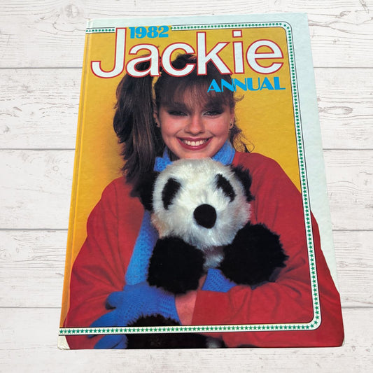1982 Jackie Annual cover with a girl holding a panda toy on a wooden surface