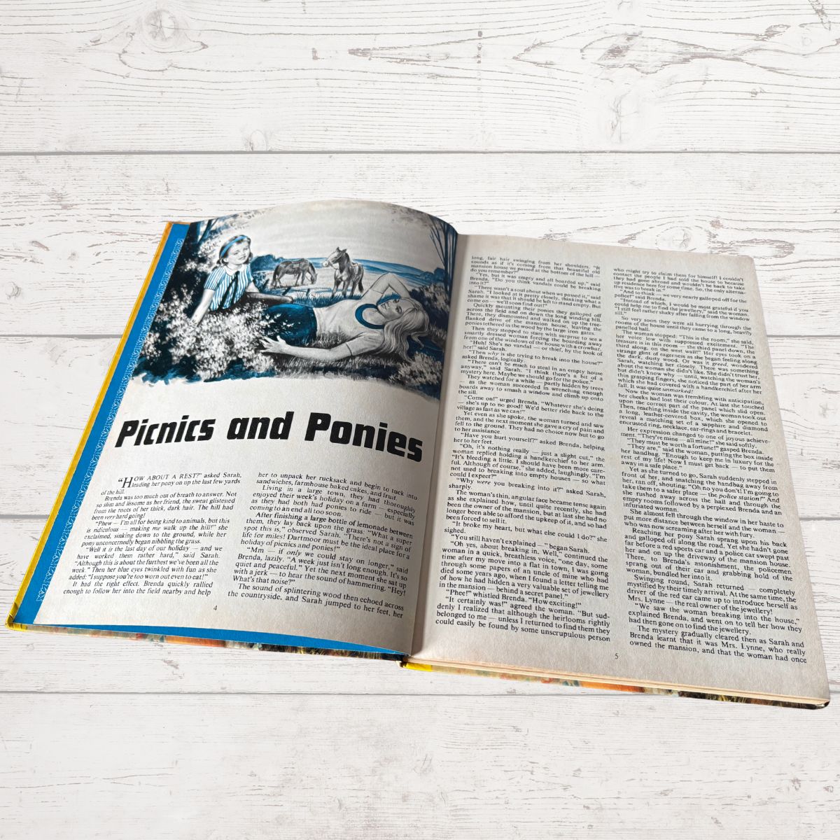 Open book on a wooden surface with text and images.